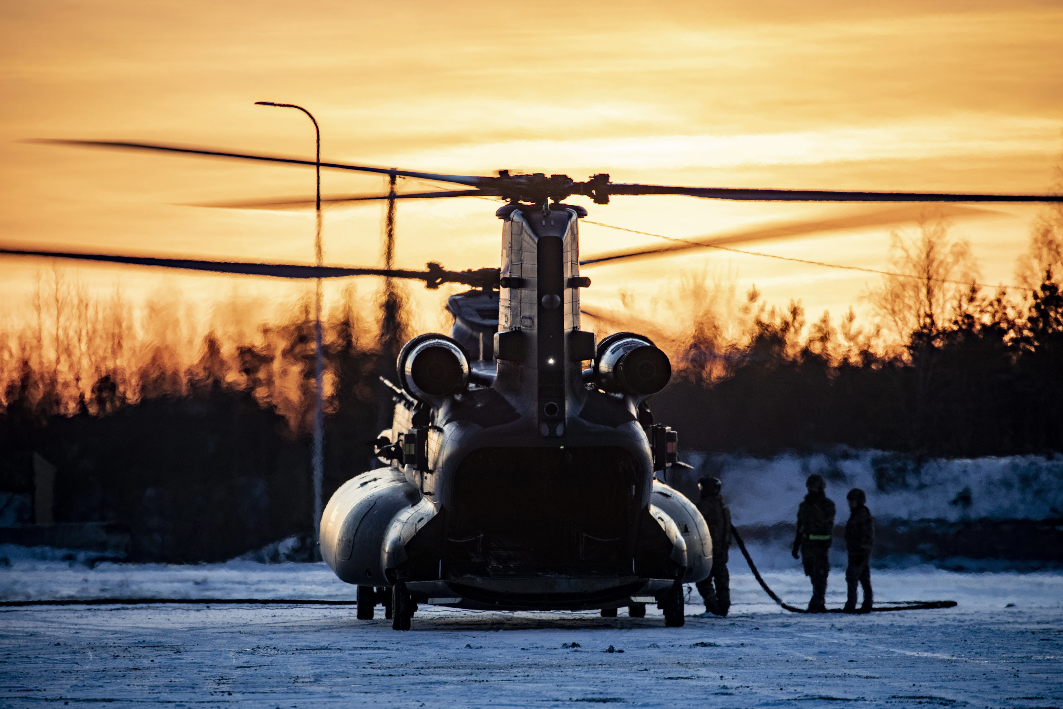 Image shows RAF Chinook on the airfield during sunset.